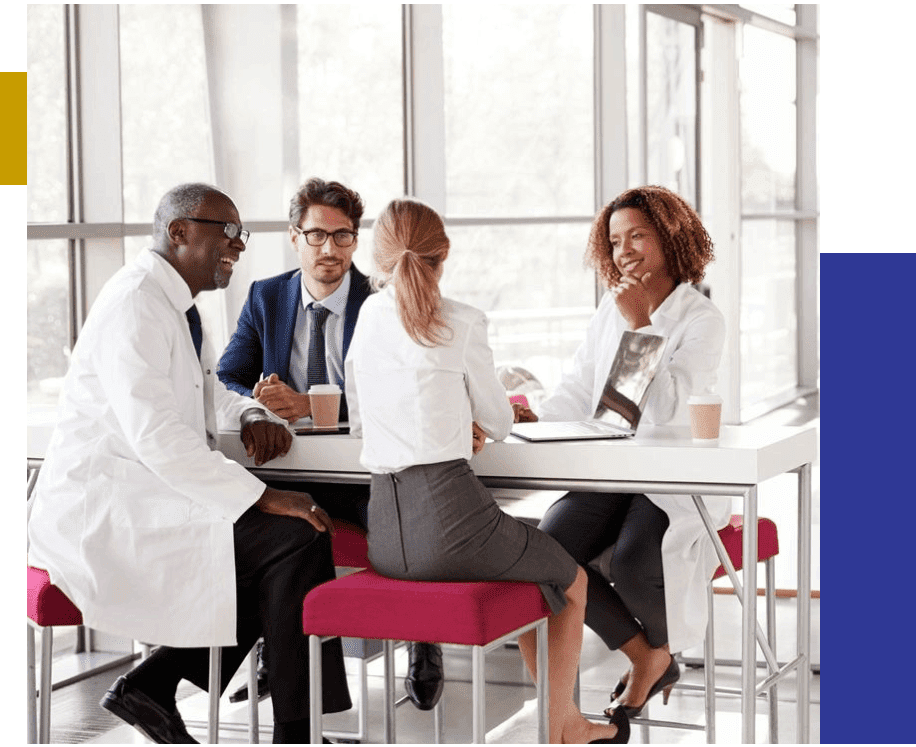 Doctors talking at a table in a modern hospital lobby