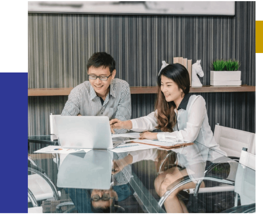 Men and Women smiling and discussing with a laptop